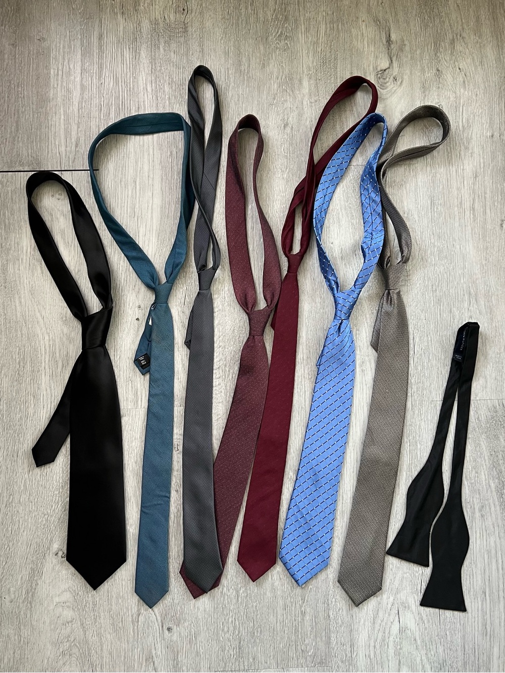 Lot of 7 ties and one bow tie in various colors and patterns